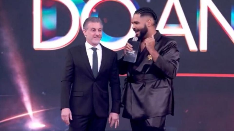 O apresentador e o humorista rindo durante premiação